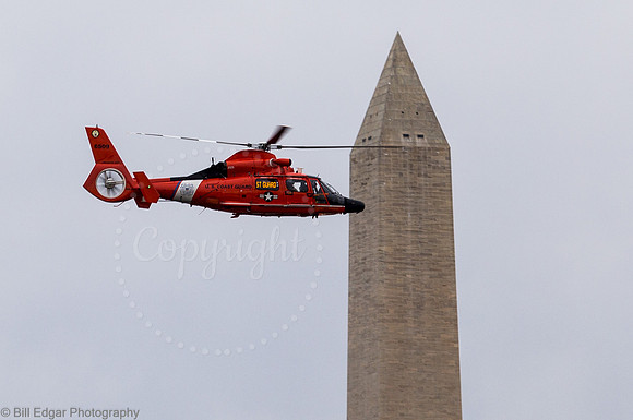 US Coast Guard HH-65 helicopter flying past the Washington Monument in DC